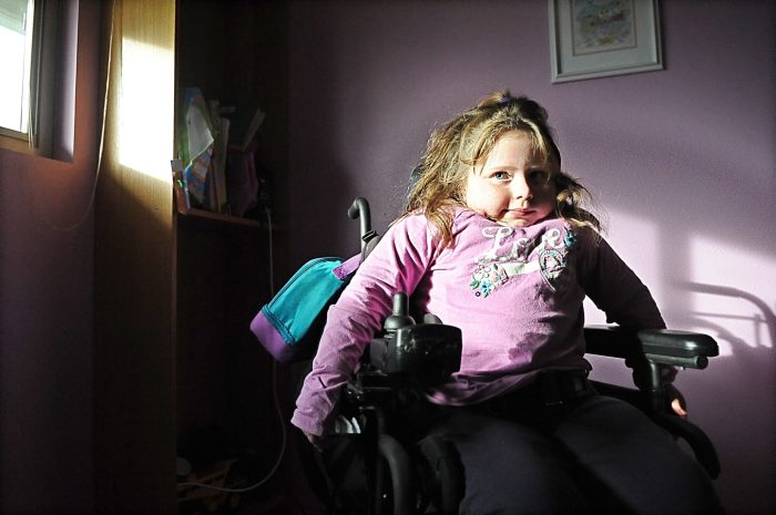 Kiley McClay spends time in her room Wednesday at her Centralia home. The 7-year-old was diagnosed at birth with muscular atrophy, a condition for which she and her family are trying to raise money and awareness to find a cure.
